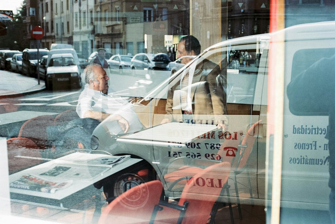 Two business partners negotiating across a table