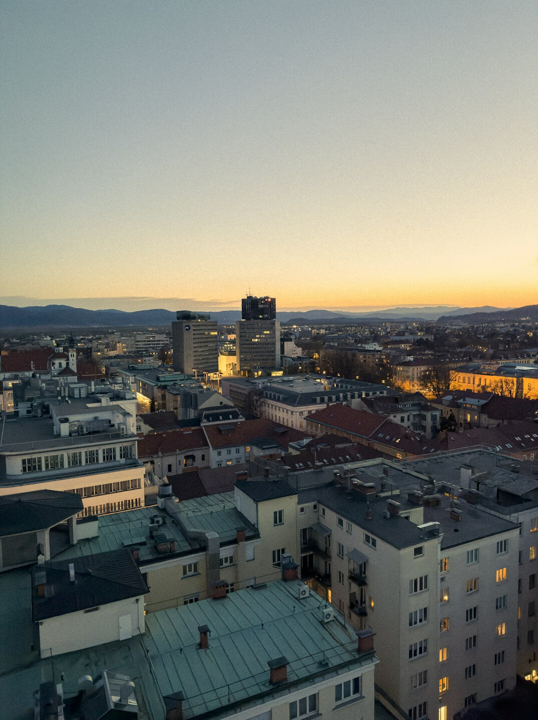 Modern glass office building in Ljubljana at sunset
